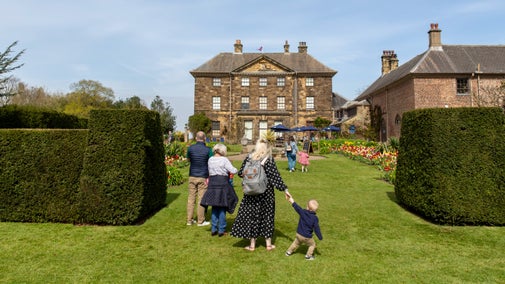 Family walking in garden in spring
